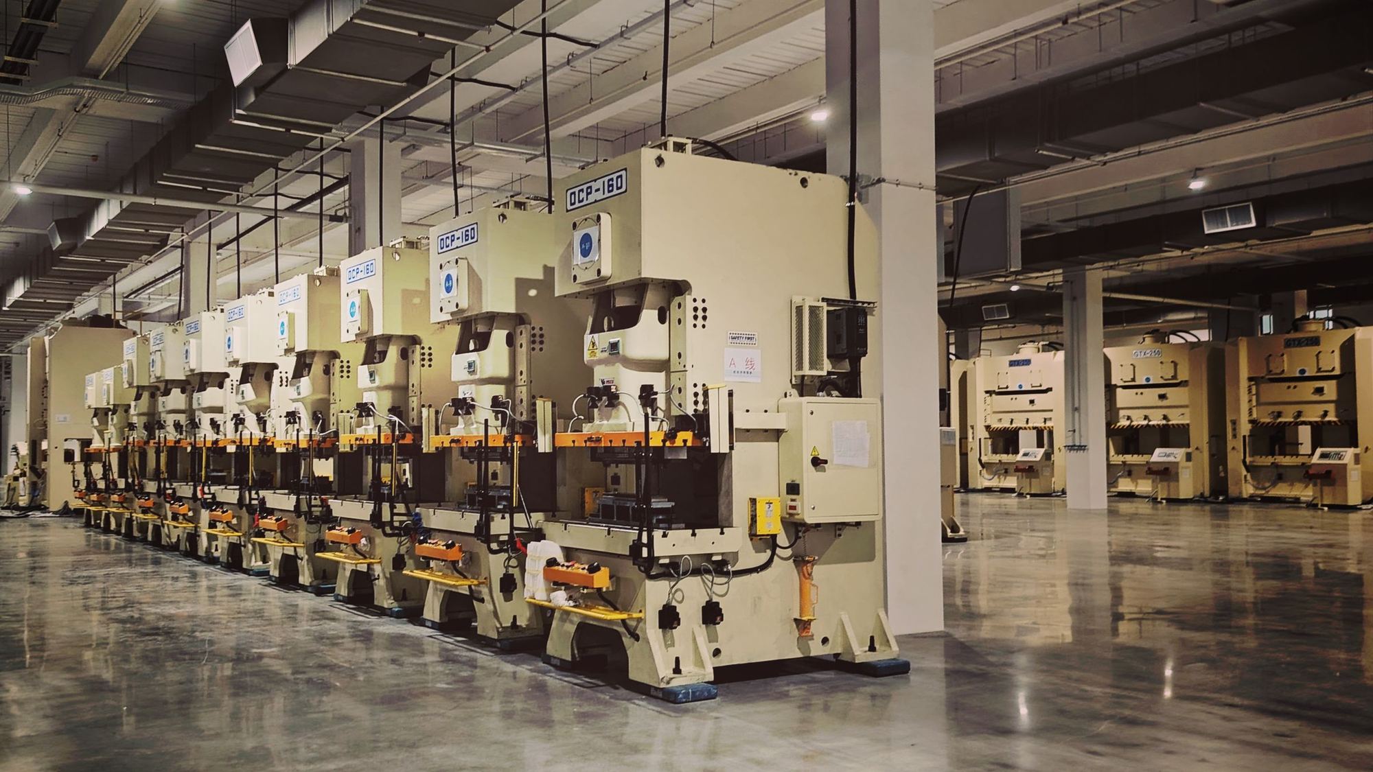 Row of industrial presses on a factory floor