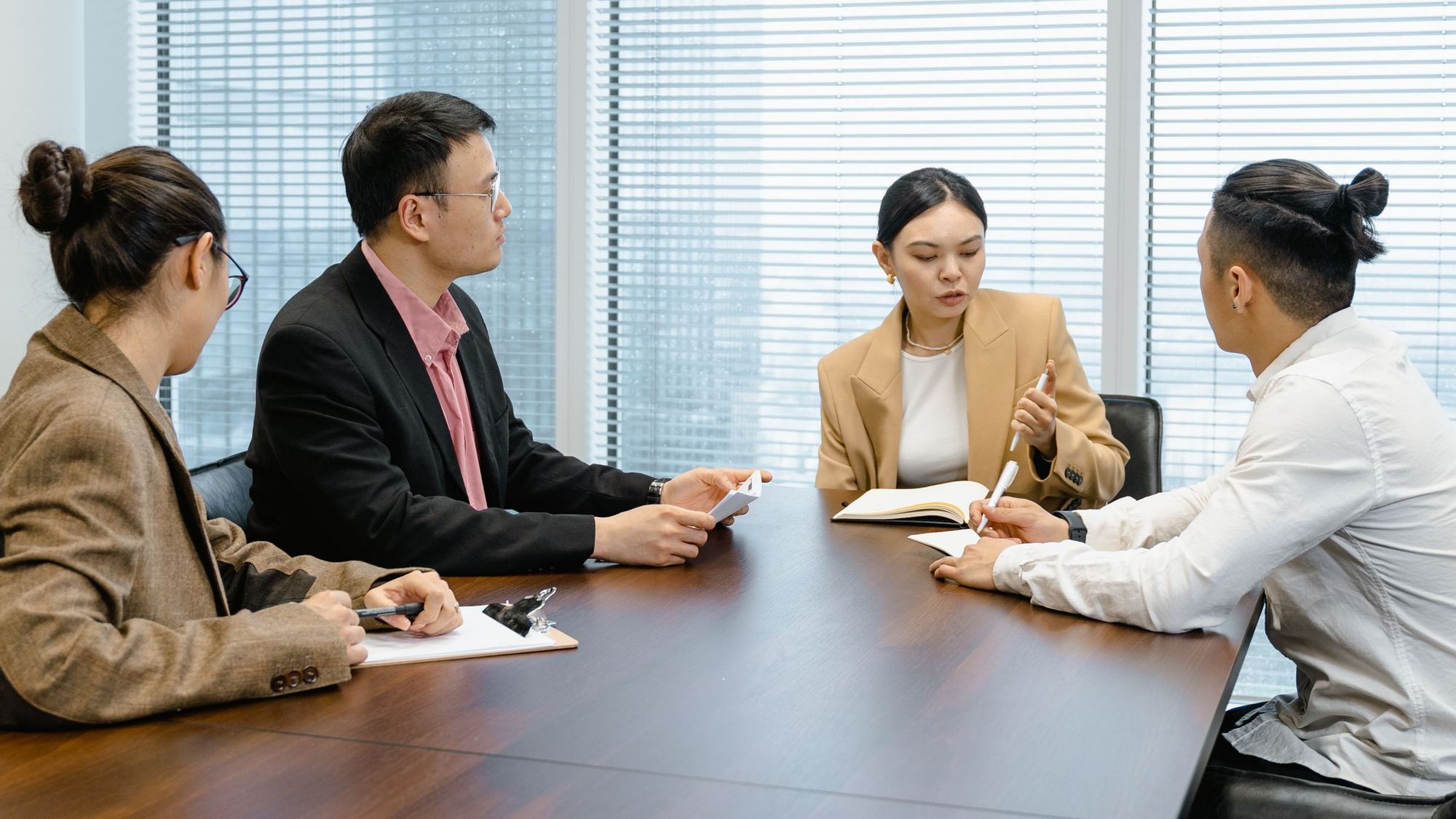 Four colleagues in a meeting at a conference table
